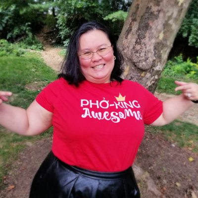 Thien-Kim wearing a read shirt that reads "Pho-king awesome"